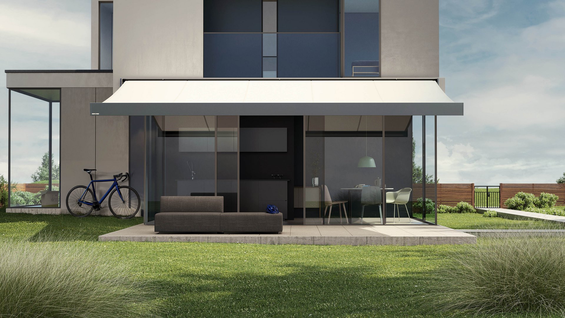 Moderne Fassade mit Überdachung, Sitzbereich und Grünflächen im Vordergrund.