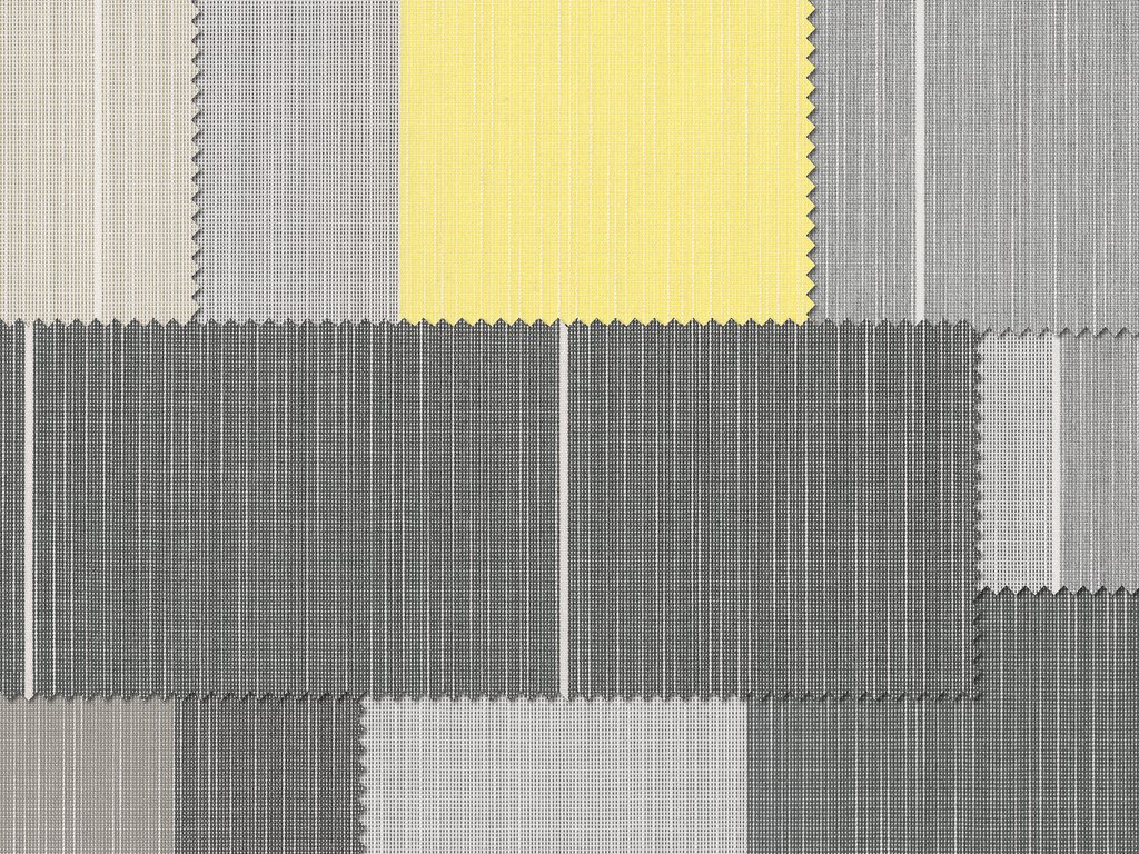 Tissu en plusieurs teintes de gris avec un carré jaune. Tissu en plusieurs teintes de gris avec un carré jaune.