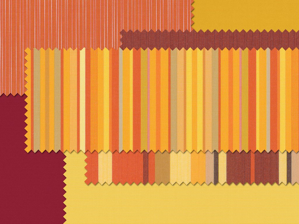 Échantillons de tissu aux motifs à rayures et carreaux, dominés par des teintes jaunes, rouges et oranges.