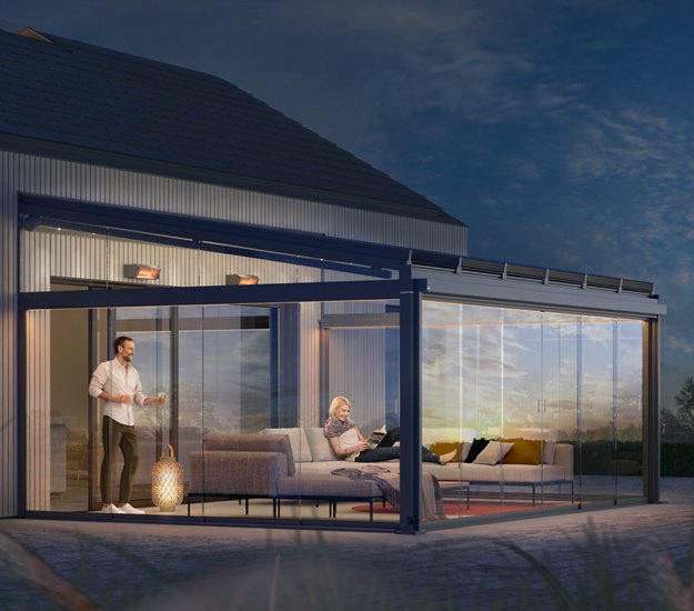 Vue d'une terrasse avec une structure moderne, verre et espace de vie en soirée. Couleurs chaudes et ambiance accueillante. 